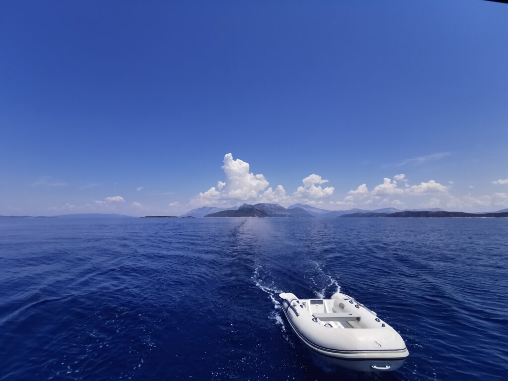 Dinghi towed behind boat